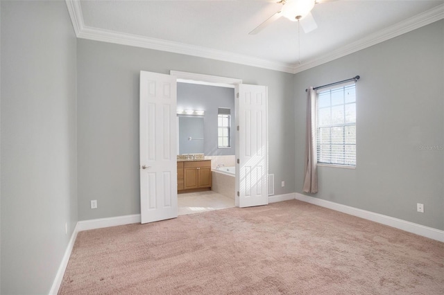 unfurnished bedroom featuring a ceiling fan, baseboards, ornamental molding, light carpet, and connected bathroom