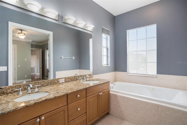 bathroom with tile patterned flooring, double vanity, a garden tub, and a sink