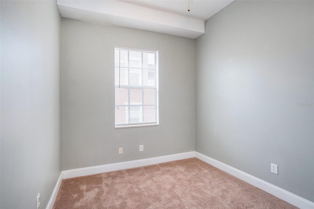 carpeted spare room with baseboards