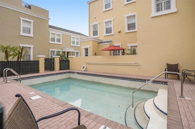 view of swimming pool with fence