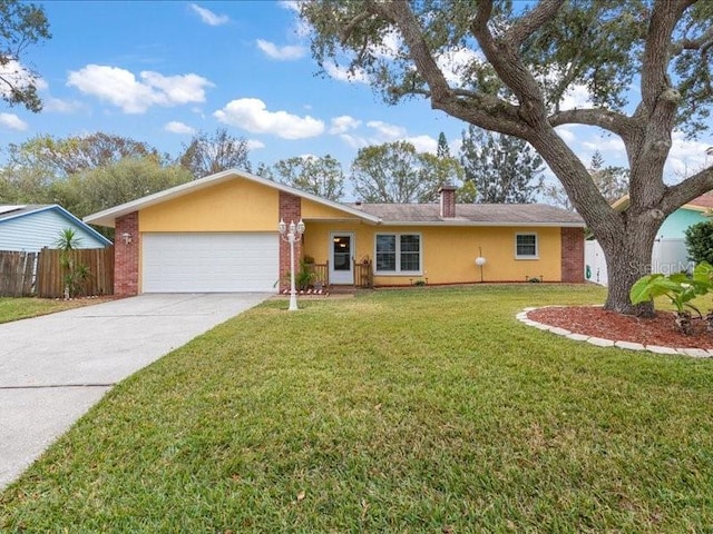 single story home featuring a garage and a front lawn