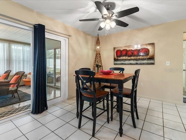 tiled dining room with ceiling fan