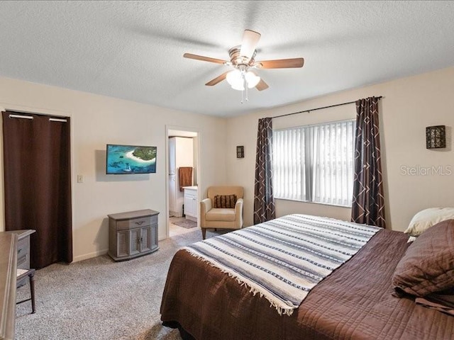 carpeted bedroom with connected bathroom, a textured ceiling, and ceiling fan