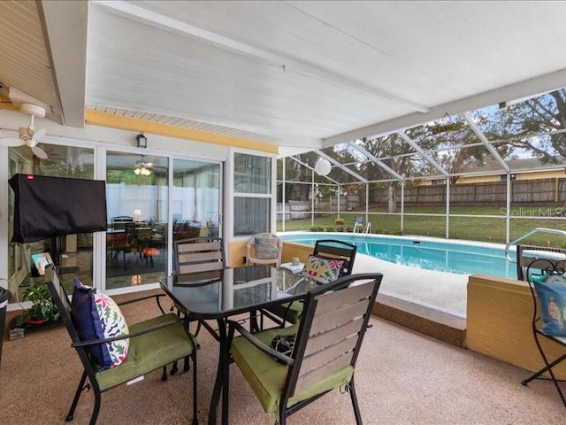 view of pool with a patio and glass enclosure