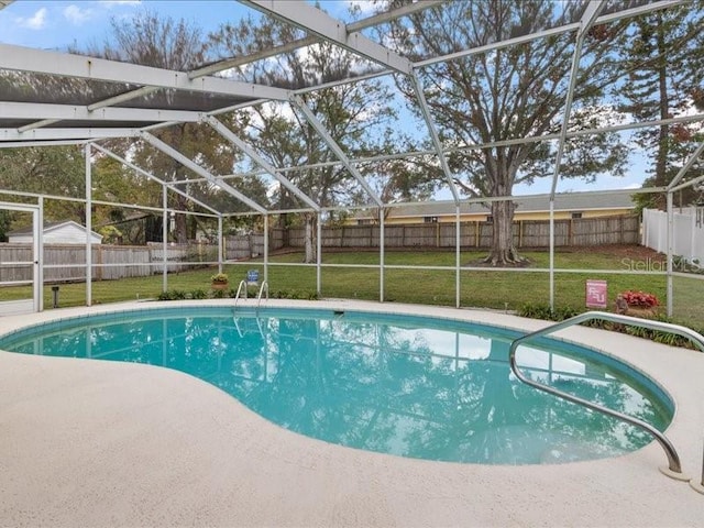 view of pool with a lanai and a lawn