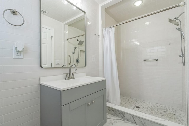 bathroom featuring tile walls, vanity, and a shower with curtain