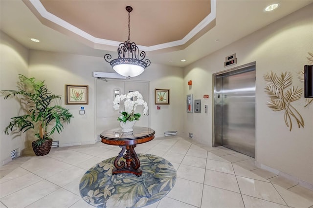 tiled foyer featuring a raised ceiling and elevator