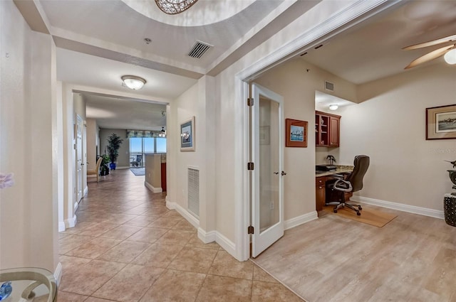 corridor with light tile patterned flooring