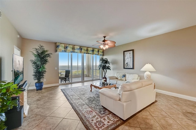 living room featuring light tile patterned floors and ceiling fan