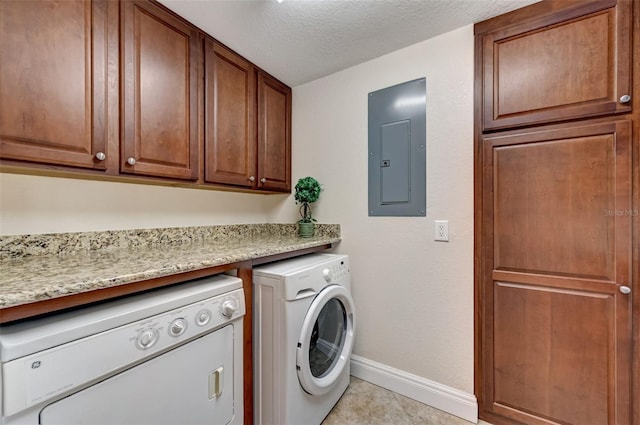 washroom featuring electric panel, cabinets, independent washer and dryer, a textured ceiling, and light tile patterned flooring