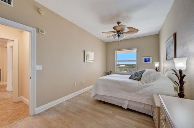 bedroom with ceiling fan and light hardwood / wood-style flooring