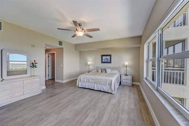 bedroom with ceiling fan and light hardwood / wood-style flooring