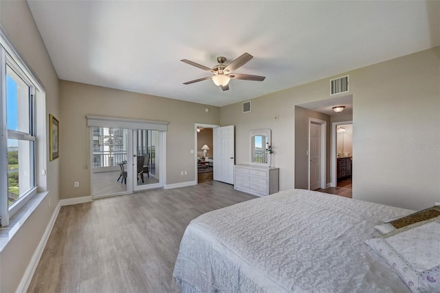 bedroom featuring hardwood / wood-style floors, access to outside, ceiling fan, and ensuite bathroom