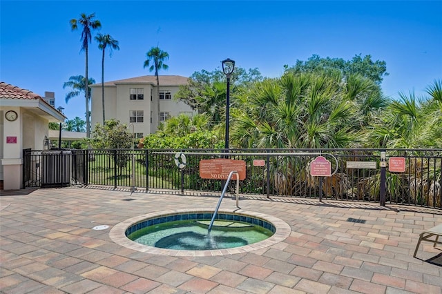 view of swimming pool with a community hot tub