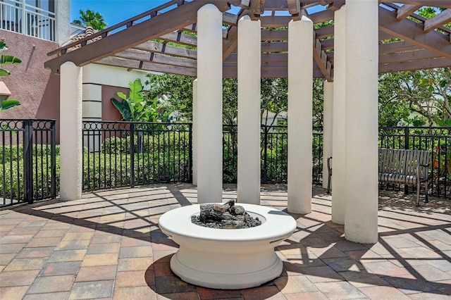 view of patio featuring a fire pit and a pergola