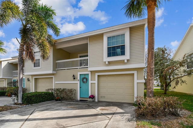 multi unit property featuring a garage and a balcony