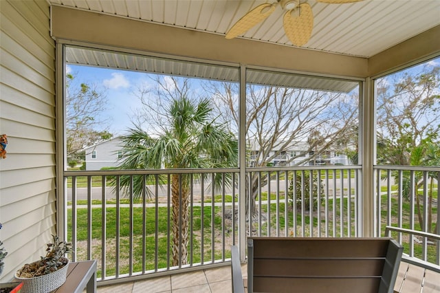 unfurnished sunroom featuring ceiling fan