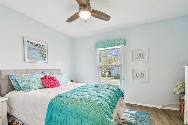 bedroom with ceiling fan and wood-type flooring