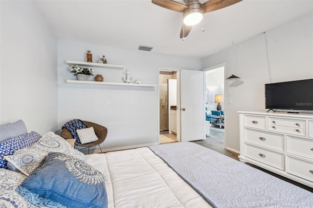 bedroom with light hardwood / wood-style flooring, ceiling fan, and ensuite bathroom