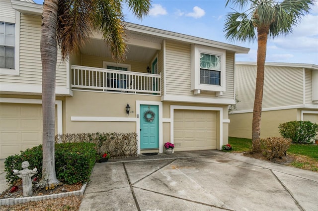 multi unit property with a garage and a balcony