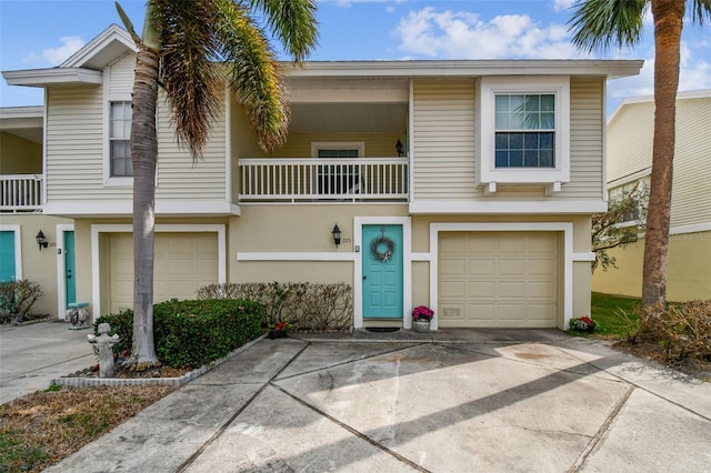 multi unit property with a garage and a balcony