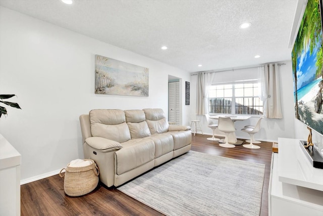 living room with hardwood / wood-style flooring and a textured ceiling