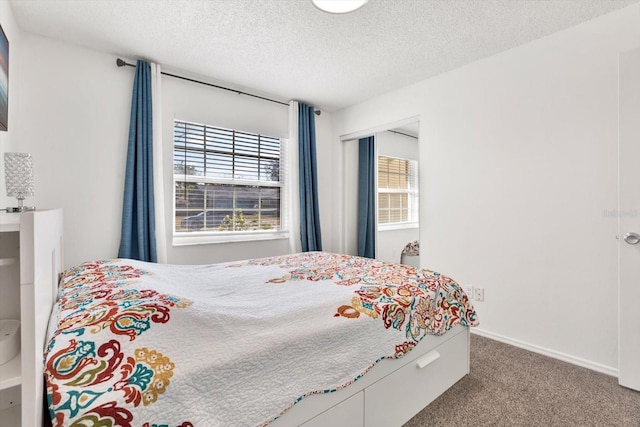 carpeted bedroom with a textured ceiling