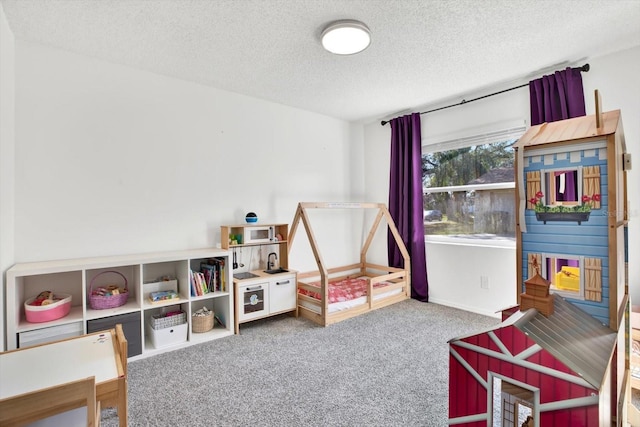 rec room with carpet floors and a textured ceiling