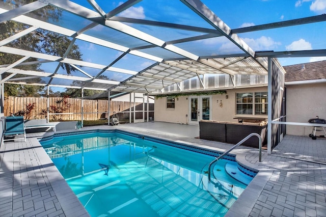 view of pool with a lanai, outdoor lounge area, a patio, and french doors