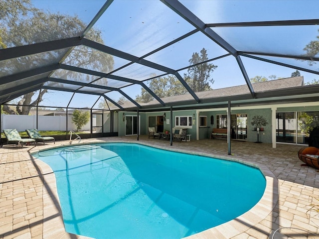 view of swimming pool with a lanai, a patio area, and a fenced in pool