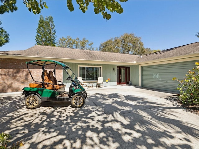 single story home with driveway and an attached garage