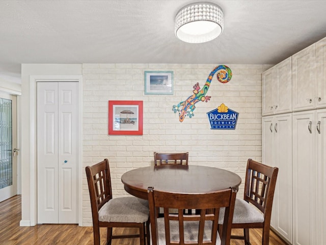 dining room featuring a textured ceiling and wood finished floors