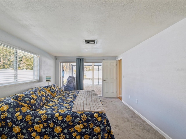 unfurnished bedroom featuring multiple windows, carpet, visible vents, and baseboards