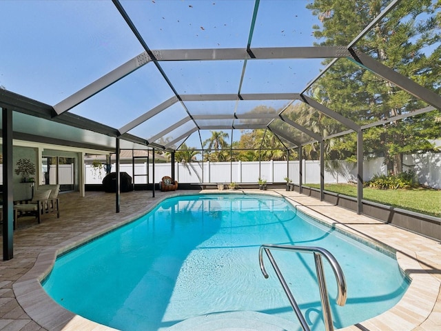 view of pool featuring a fenced in pool, glass enclosure, a fenced backyard, and a patio