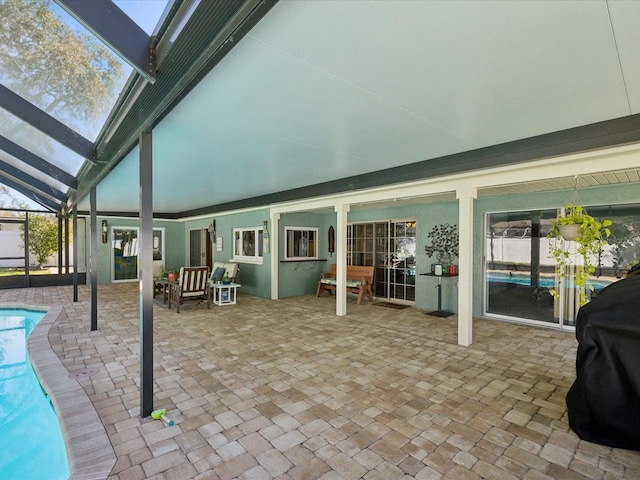 view of patio / terrace featuring a lanai, a grill, and a fenced in pool