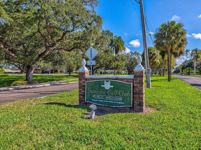 community / neighborhood sign with a lawn