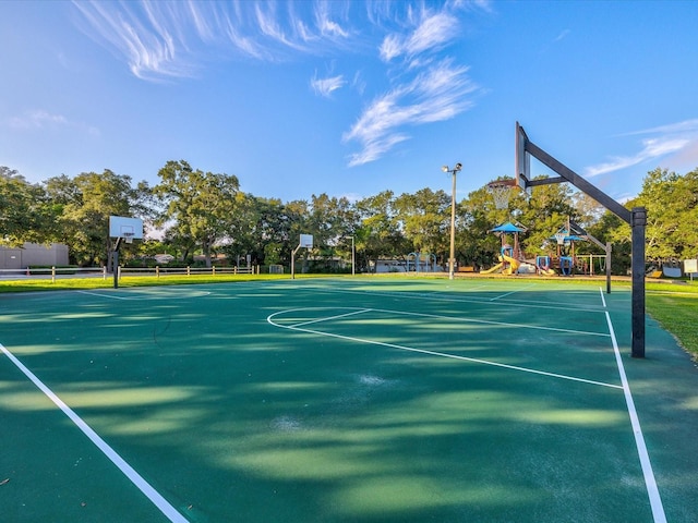 view of sport court featuring community basketball court and playground community