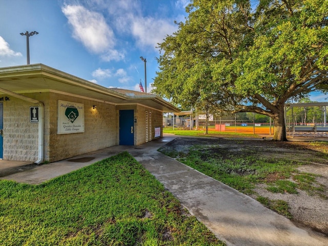 exterior space featuring fence and concrete block siding