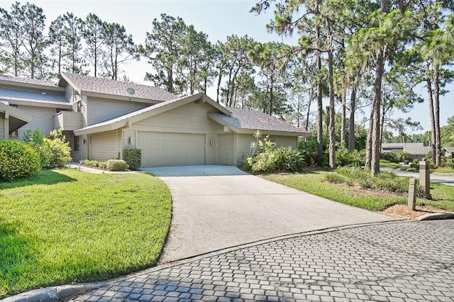 view of front of property with a garage and a front lawn