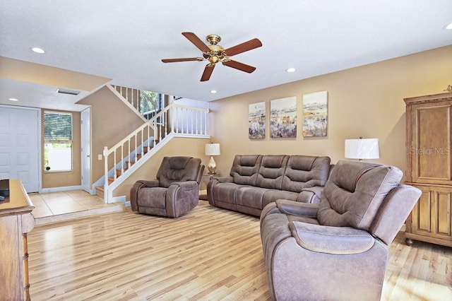 living room with ceiling fan and light hardwood / wood-style flooring