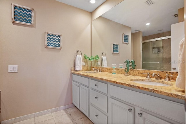 bathroom with tile patterned flooring, vanity, and a shower with shower door