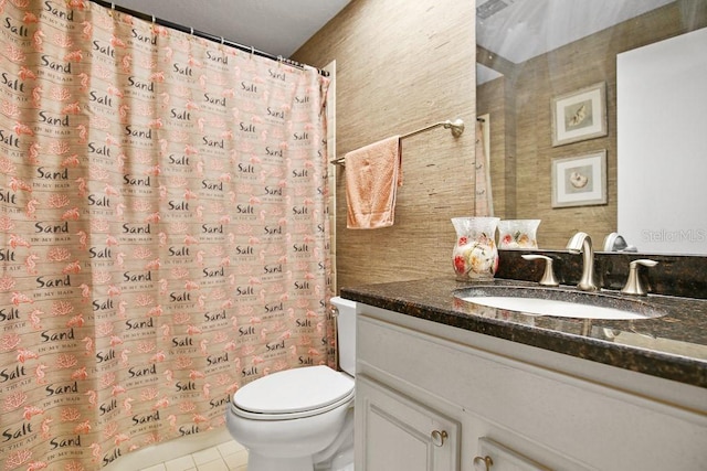 bathroom with vanity, tile patterned floors, and toilet