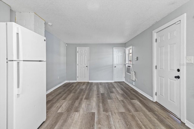 interior space with hardwood / wood-style floors and a textured ceiling