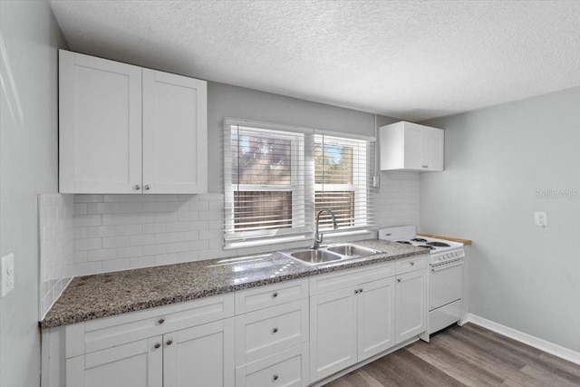 kitchen with white electric range, dark hardwood / wood-style floors, sink, and white cabinets