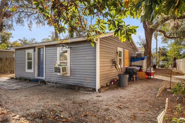 rear view of property with cooling unit