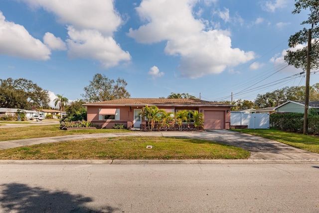 ranch-style home with a garage and a front lawn