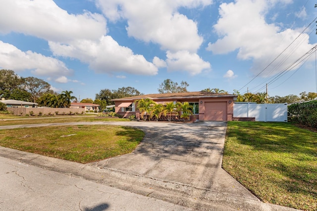 ranch-style house with a garage and a front lawn