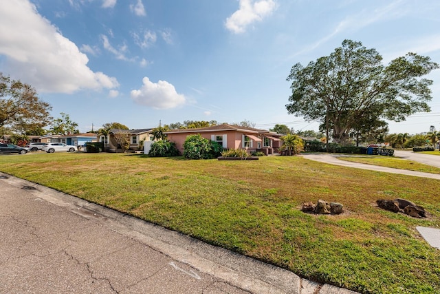 ranch-style home with a front lawn