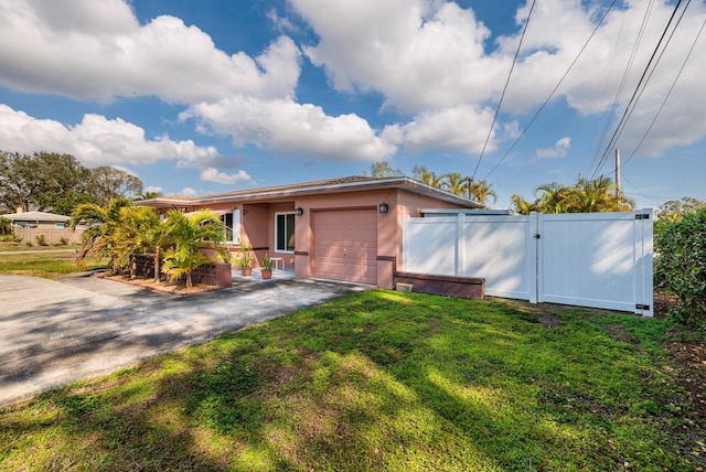 exterior space featuring a garage and a lawn