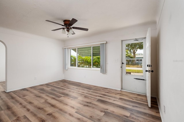 foyer with ceiling fan and light wood-type flooring